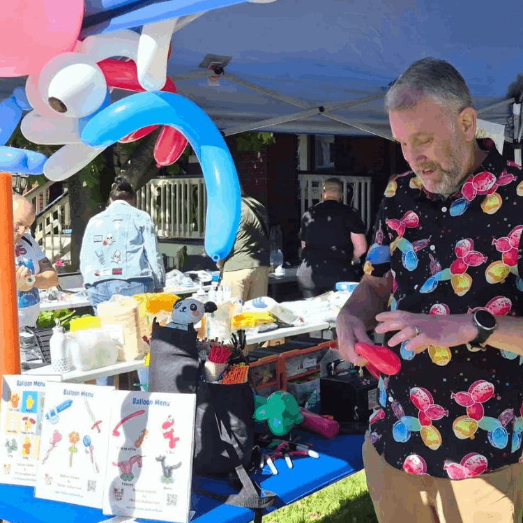 Phil the Balloon Guy twisting balloons at event in Hamilton