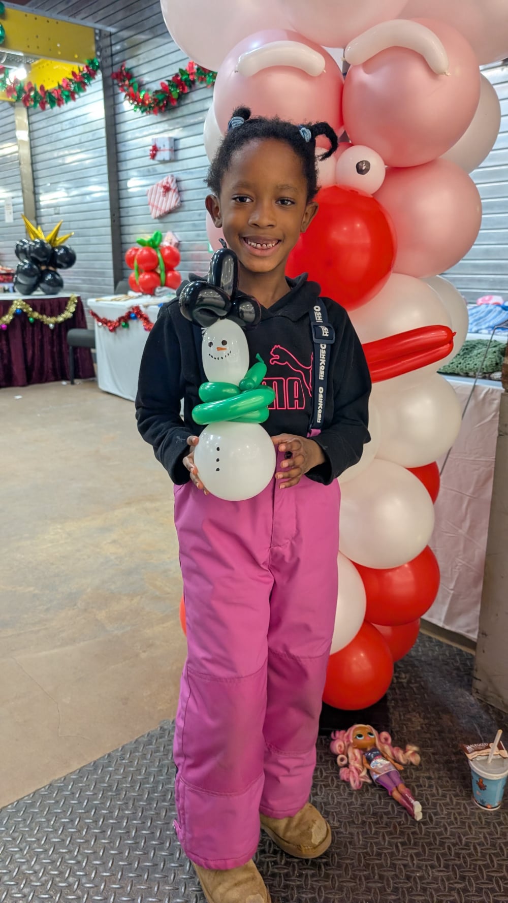 Girl with balloon scuplter snow man by santa balloon column in Eastgate Mall Hamilton