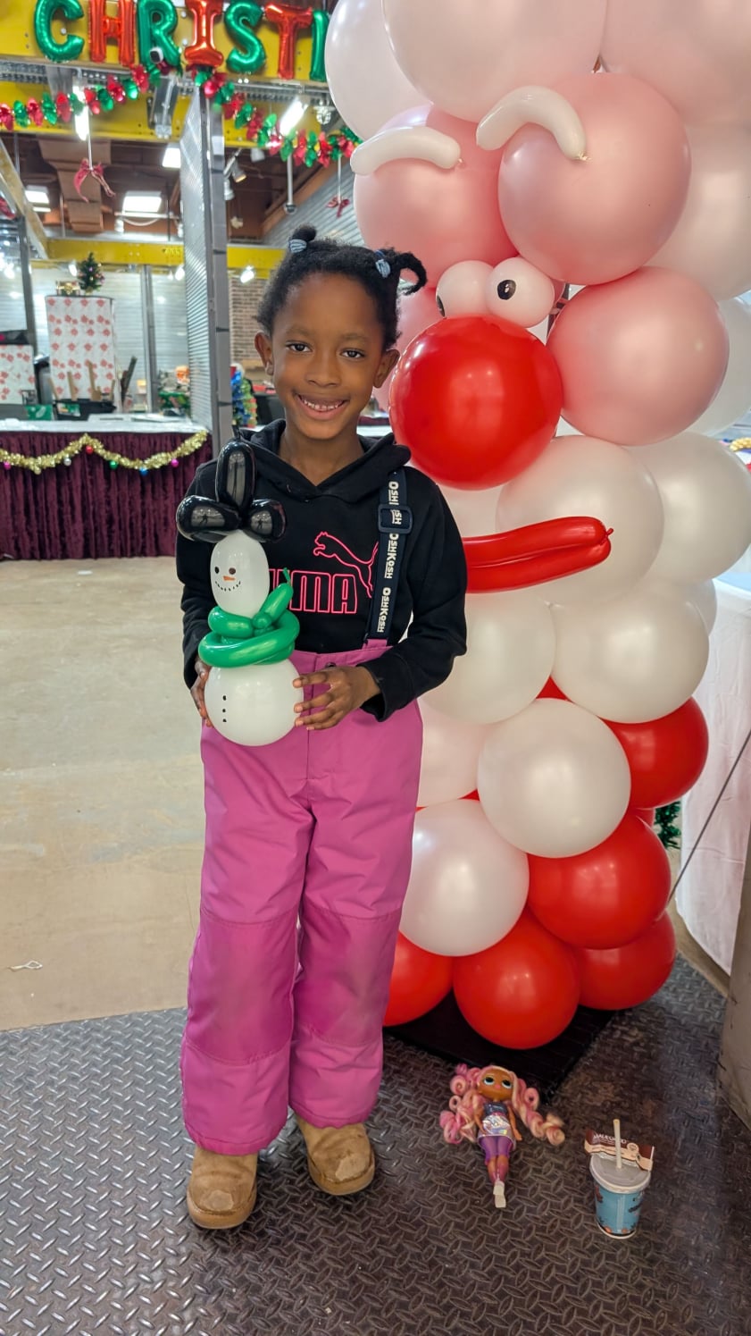 Kids Christmas party girl with balloon snowman and balloon Santa column Hamilton ON